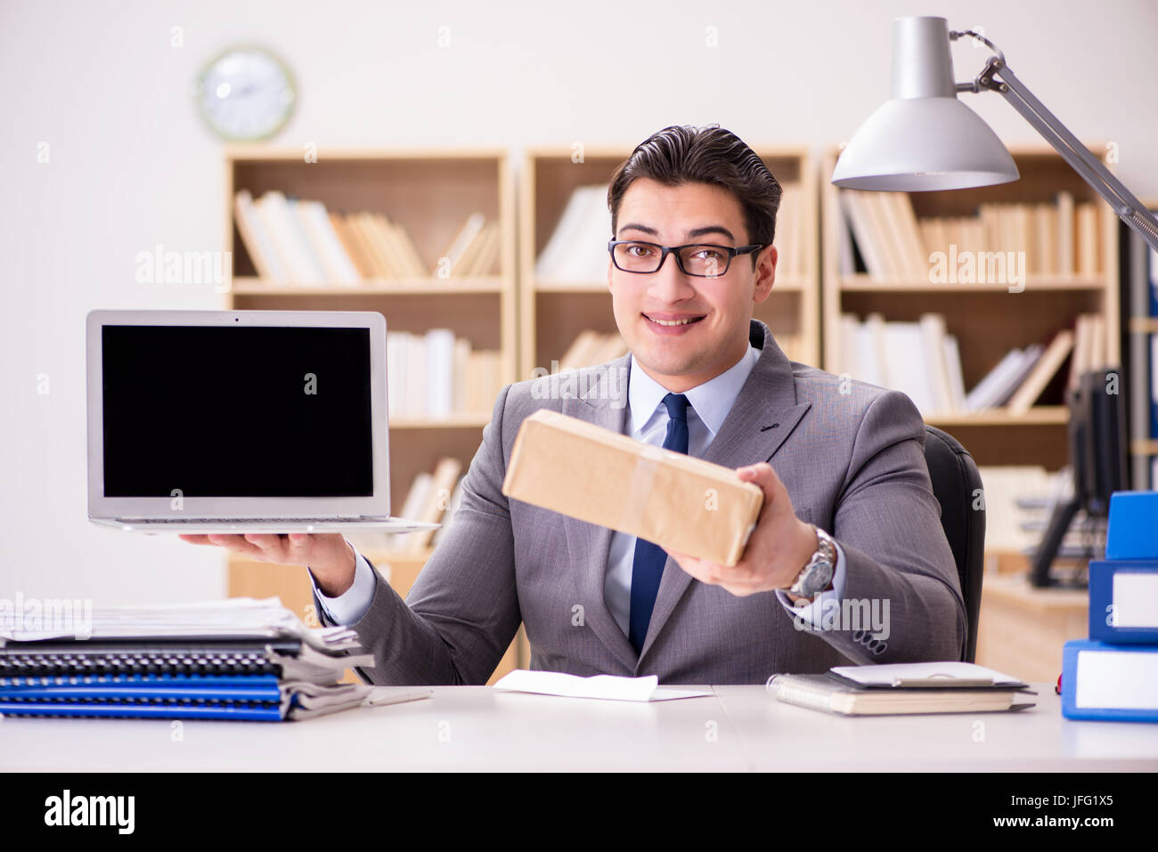 Businessman receiving parcel in the office Stock Photo - Alamy