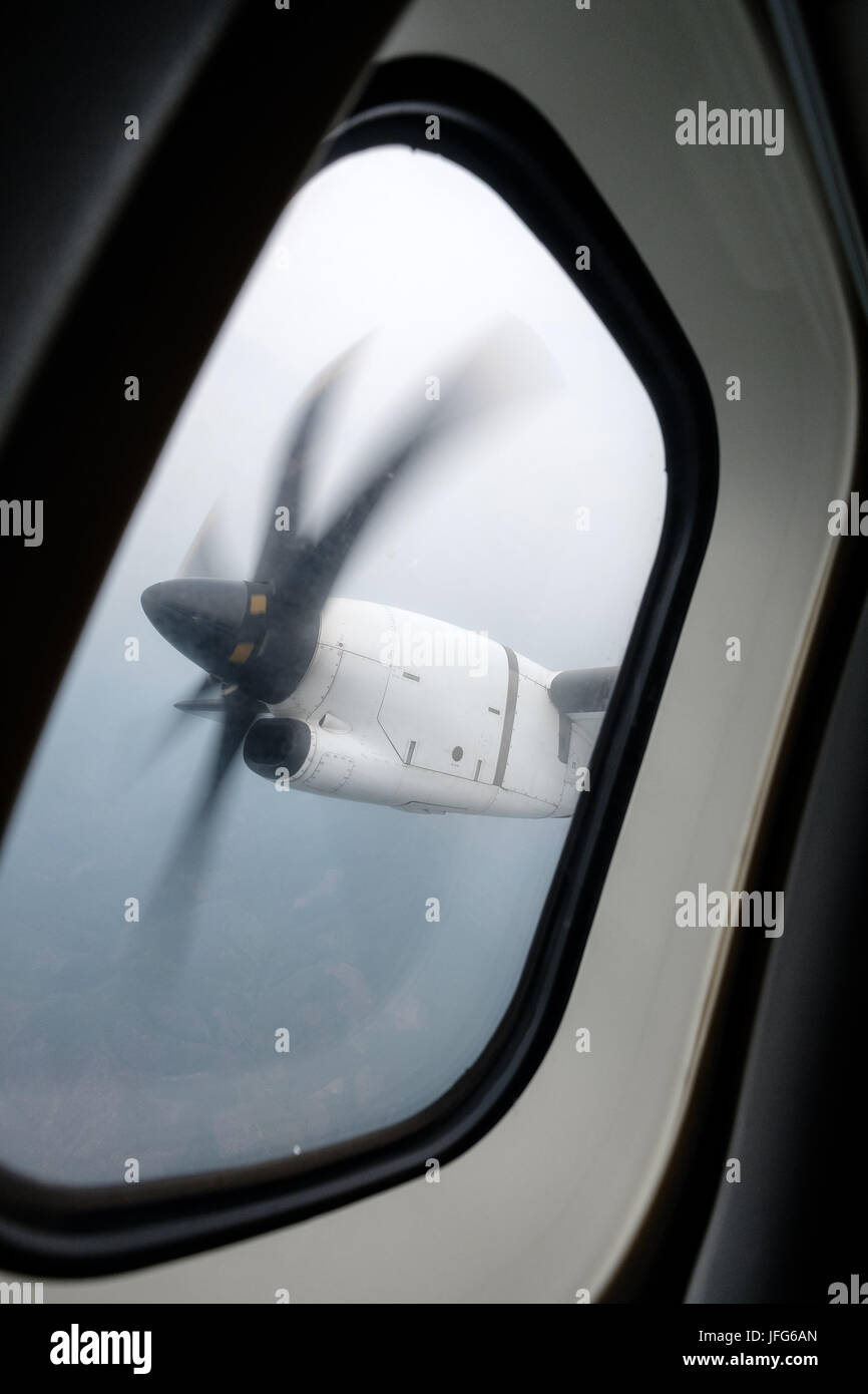 Window view of an engine propeller airplane viewed from inside the aircraft Stock Photo