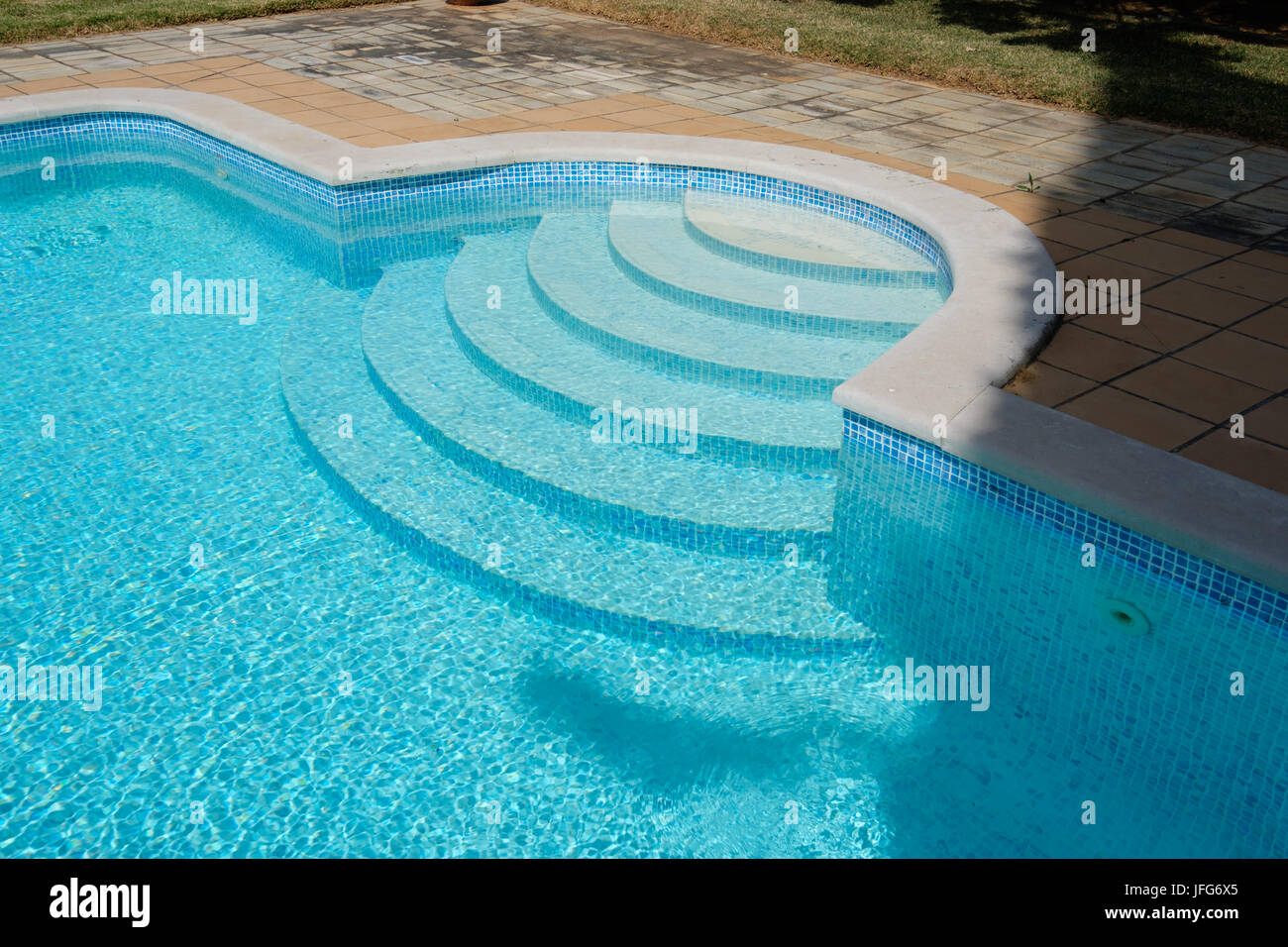 Entry steps to an outdoor swimming pool Stock Photo