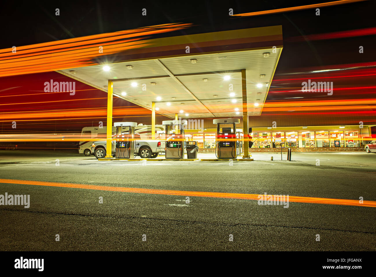 busy fueling gas station at night in USA Stock Photo