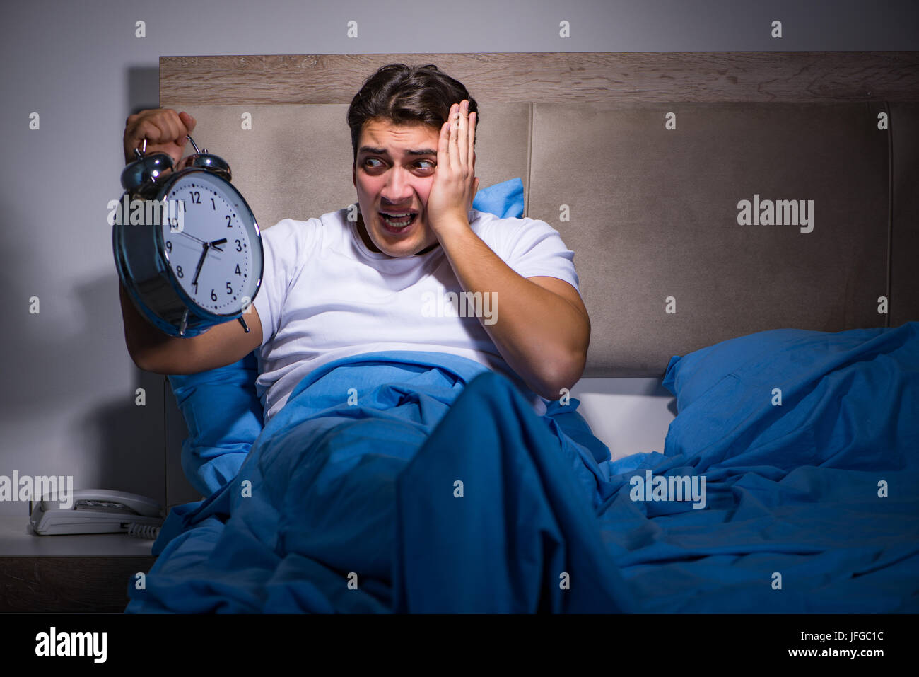Man having trouble sleeping in bed stock photo alamy