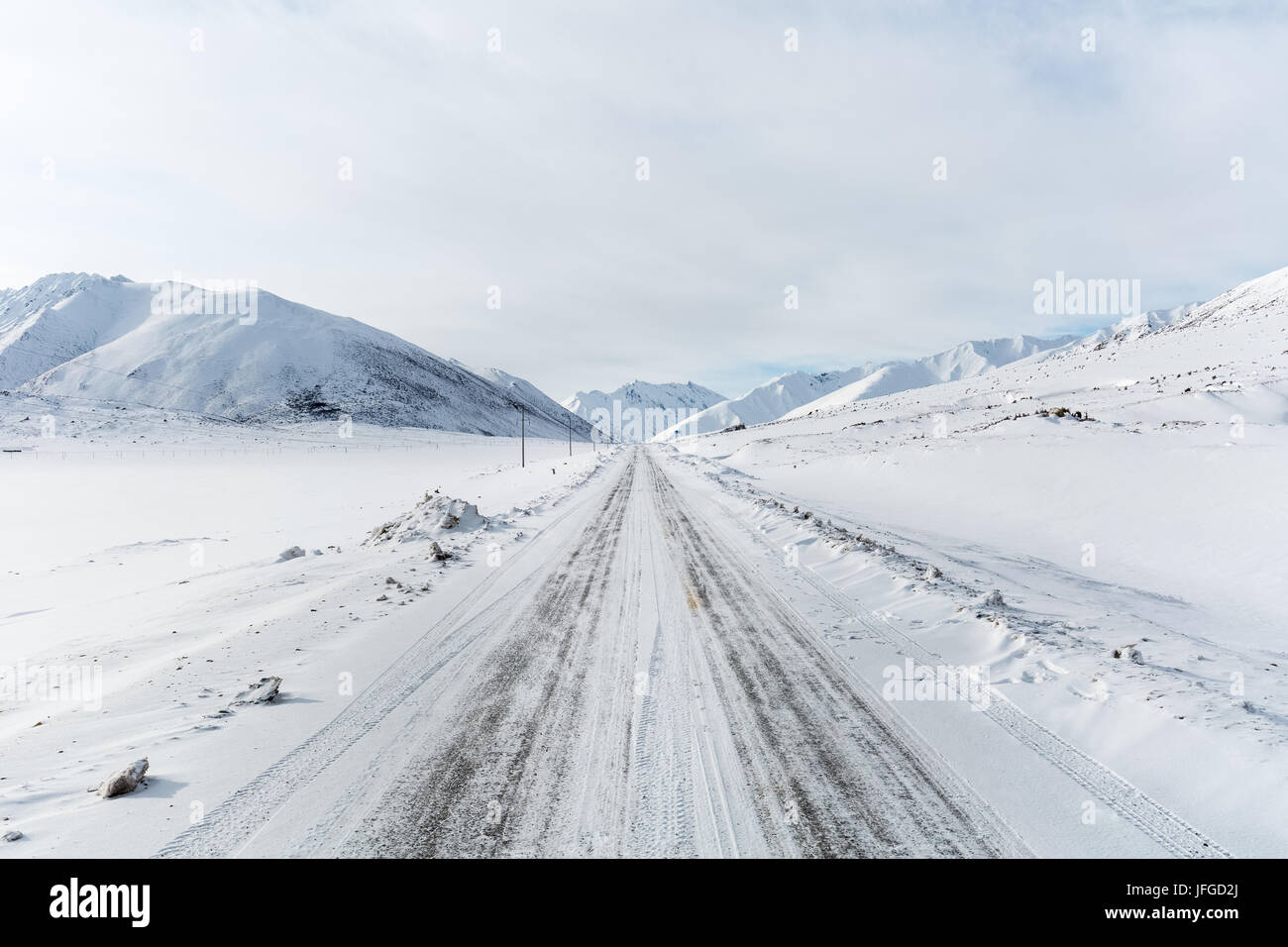 straight road in snow mountain Stock Photo
