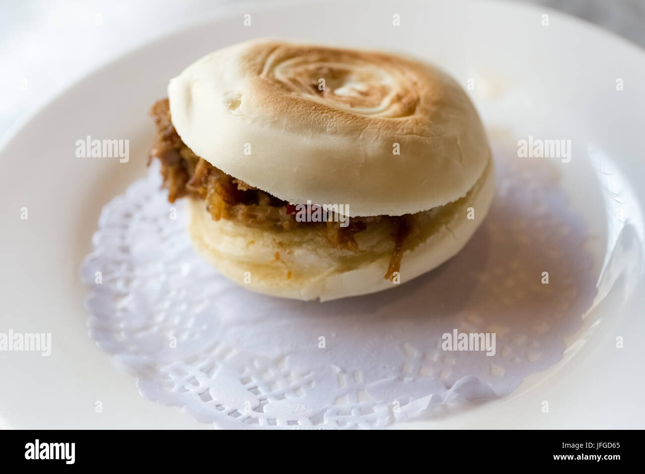 marinated meat in baked bun Stock Photo