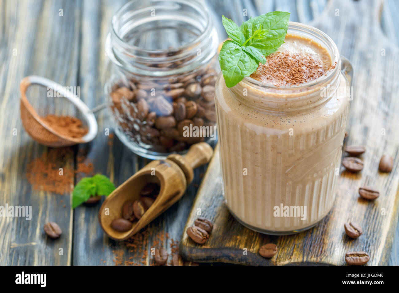 Coffee smoothie with banana in a glass jar. Stock Photo