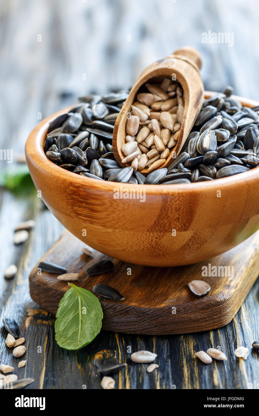 Bowl of sunflower seeds and wooden scoop. Stock Photo