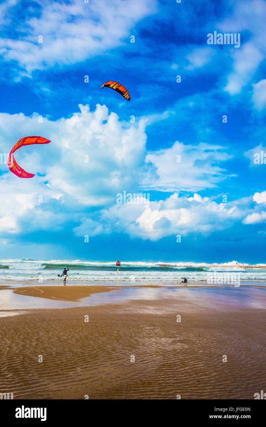 Kitesurfers ride dangerous waves Stock Photo