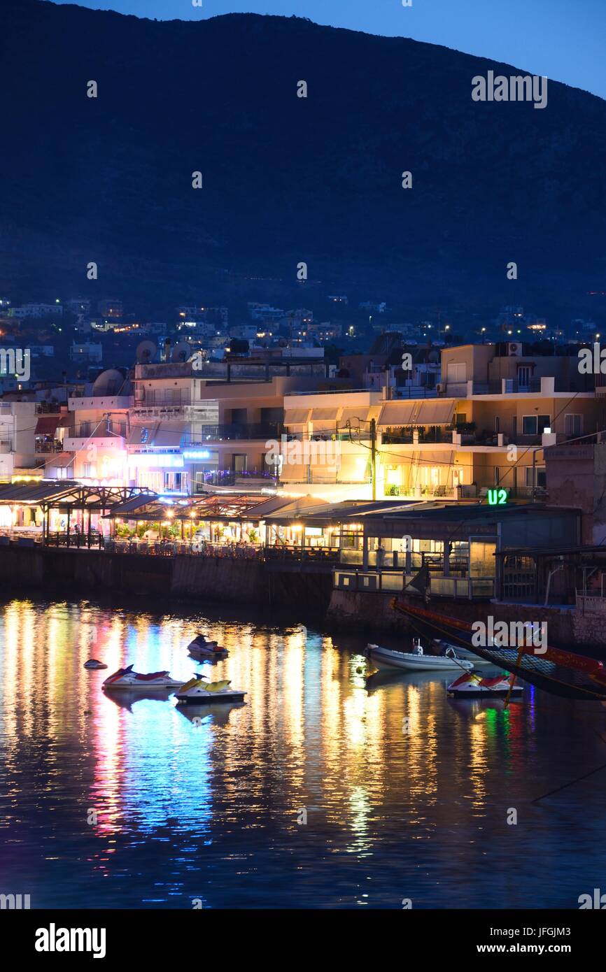 View of harbour and waterfront restaurants at dusk, Hersonissos, Crete