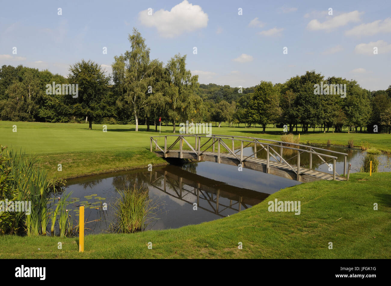 View over Pond with footbridge to 6th Green East Course, Sundridge Park Golf Club, Bromley, Kent, England Stock Photo