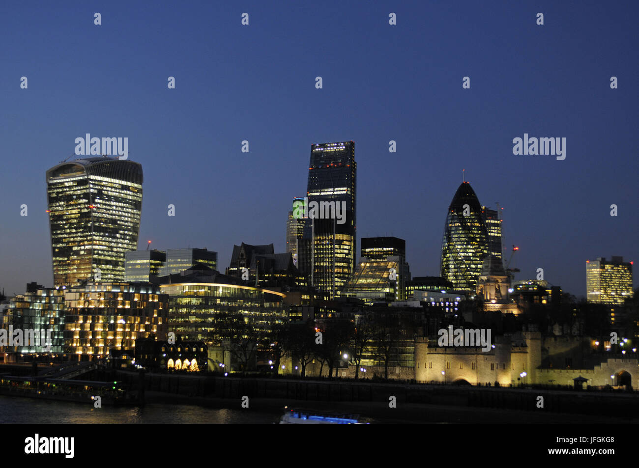 The Modern skyline of the City of London with The Walkie Talkie Building, The Gherkin, The Cheesegrater and Tower of London at night, London, England Stock Photo