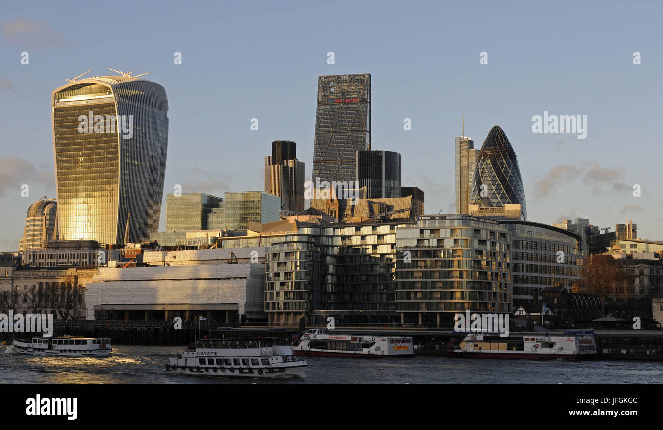The Modern skyline of the City of London with The Walkie Talkie Building, The Gherkin, The Cheesegrater at sundown and the River Thames, London, England Stock Photo