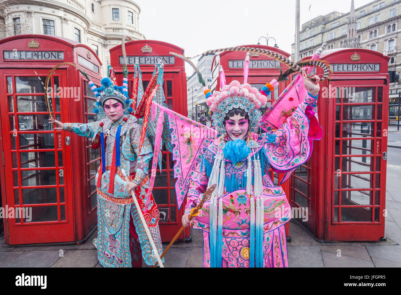 England, London, Soho, Chinatown, Chinese New Year Festival Parade, Couple Dressed in Chinese Opera Costume and Telephone Boxes Stock Photo