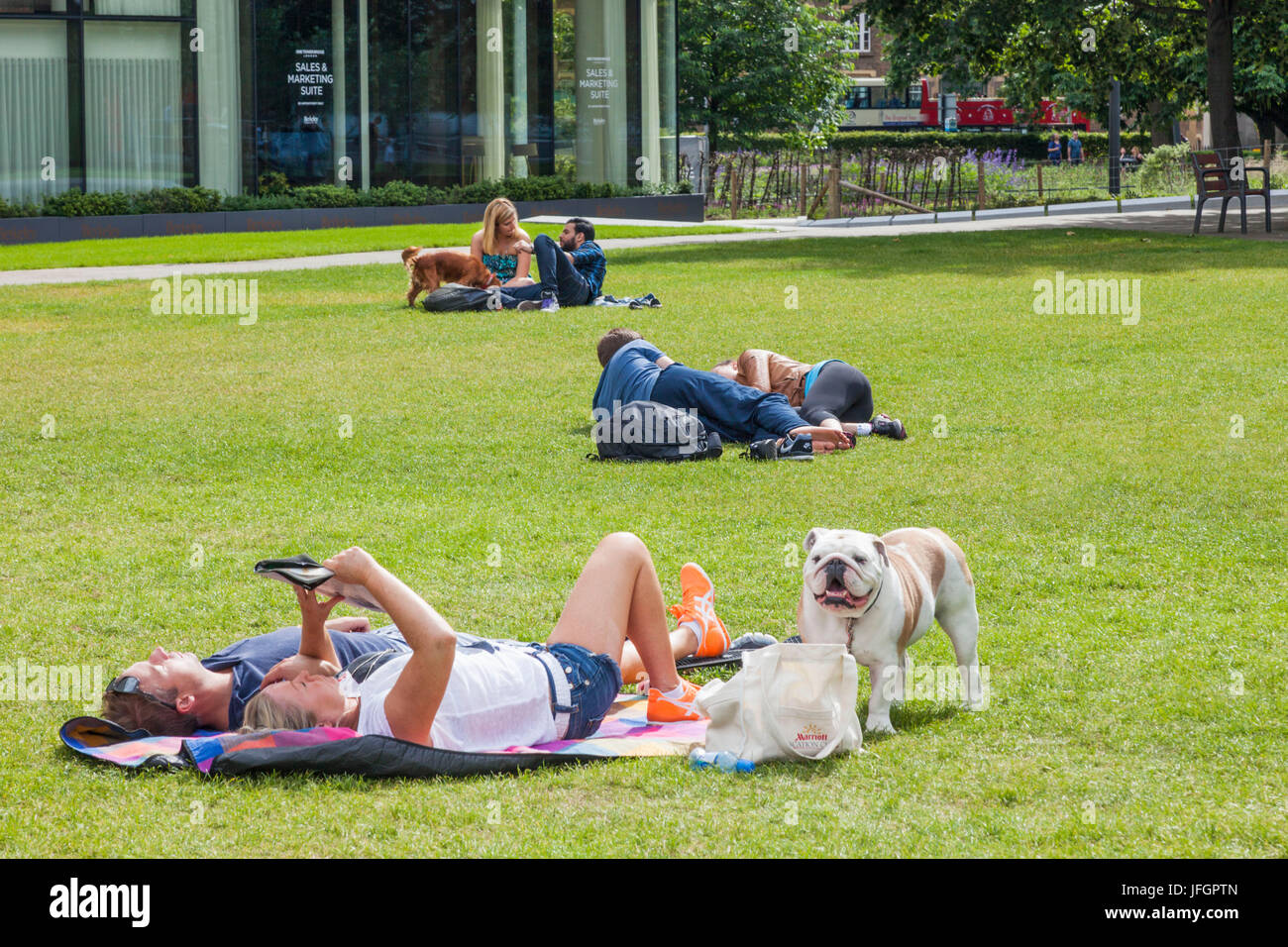 England, London, Southwark, Couples Relaxing in Potters Field Stock Photo