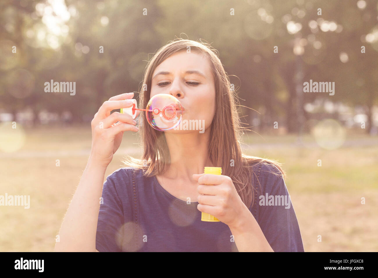 Young woman makes soap bubbles Stock Photo Alamy