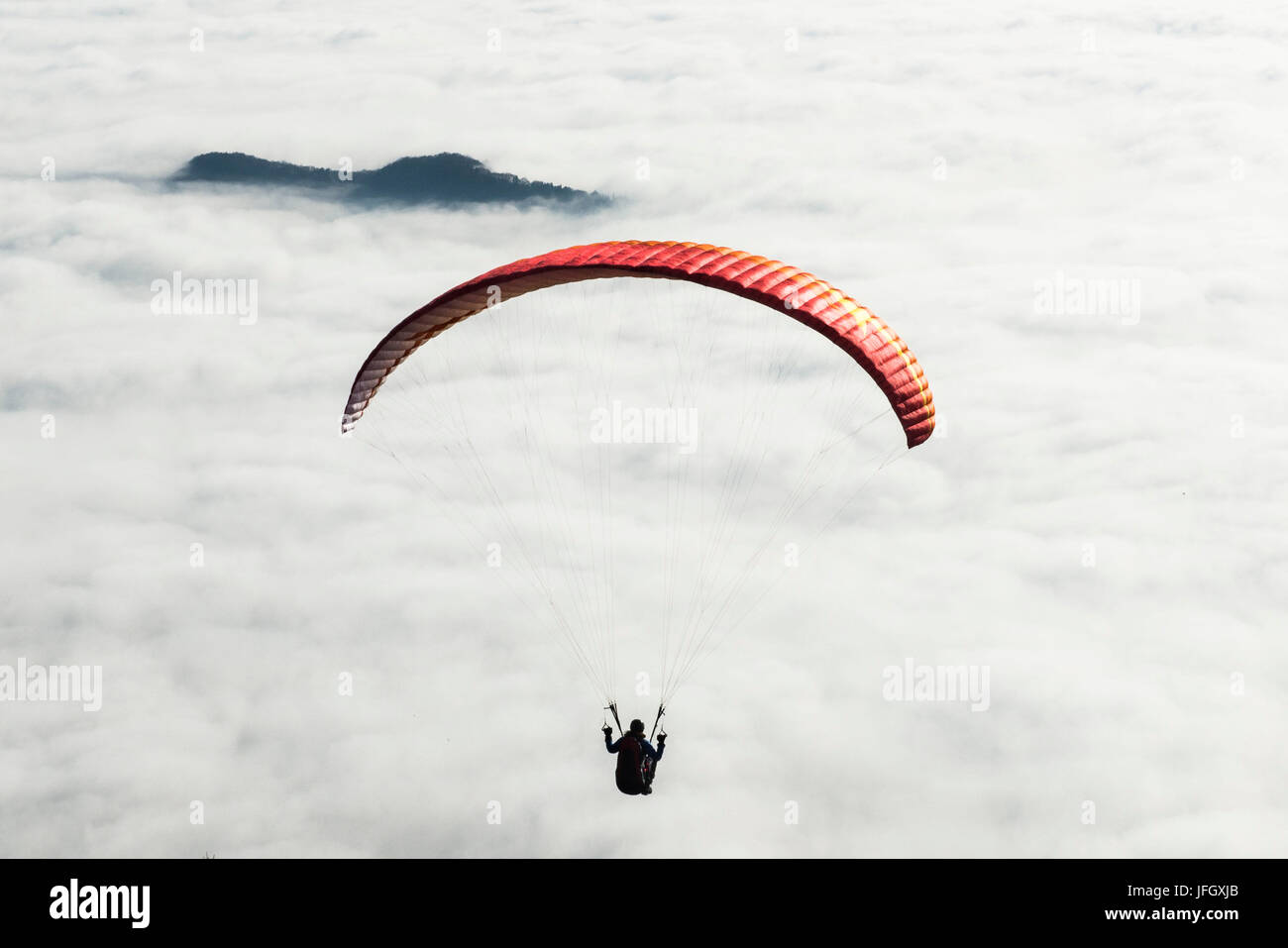 Paraglider about inversion layer, aerial picture, the sun, ground fog, Bassano, Monte Grappa, Veneto, Italy Stock Photo