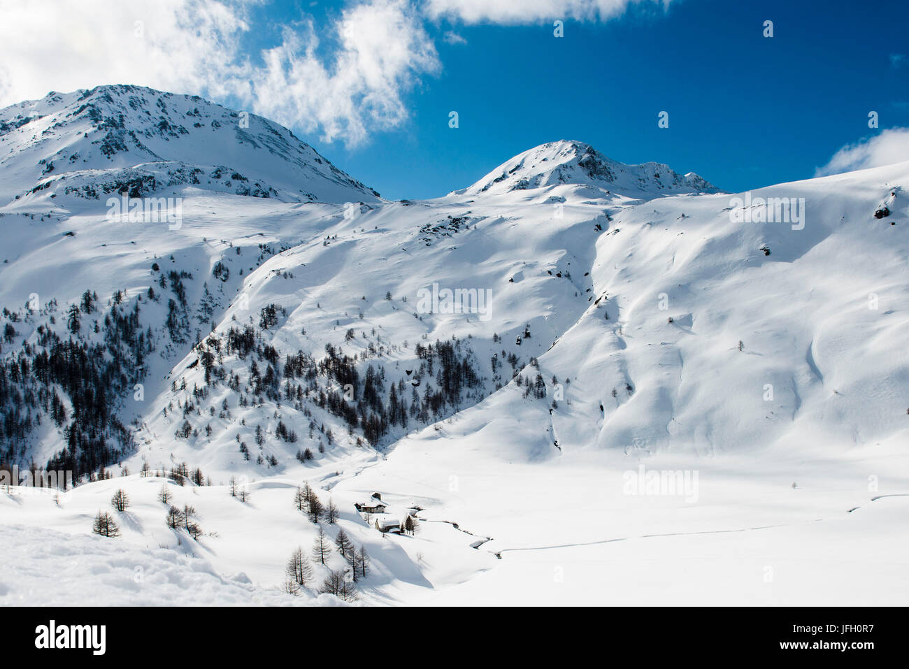 Winter scenery in the Simplonpass with old mountain hut, Valais, Switzerland Stock Photo