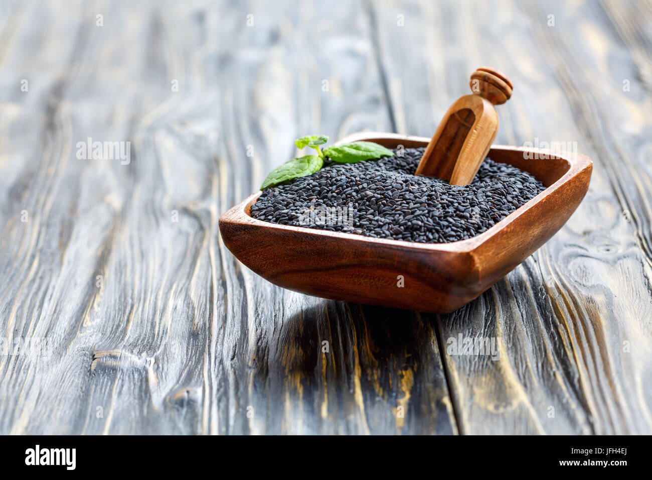 Black sesame seeds in a wooden bowl Stock Photo - Alamy