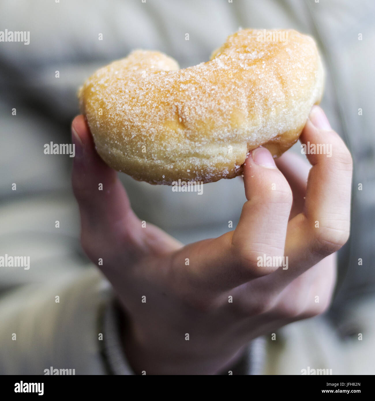 Children's hand holds donut Stock Photo