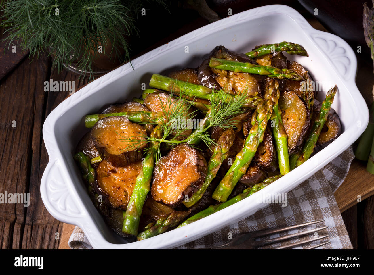 Baked eggplant with green asparagus Stock Photo Alamy
