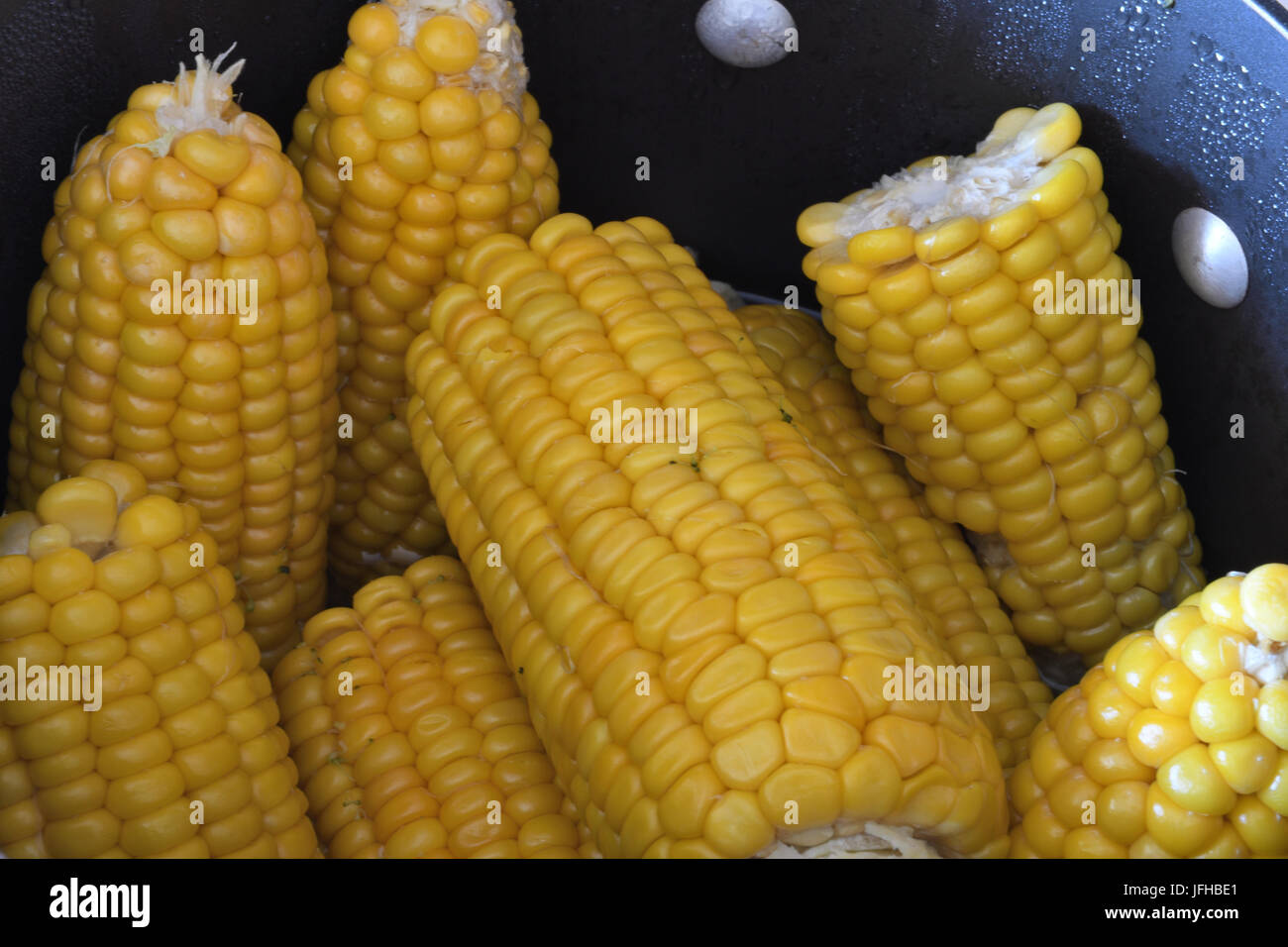 corn on the cob in black pot Stock Photo