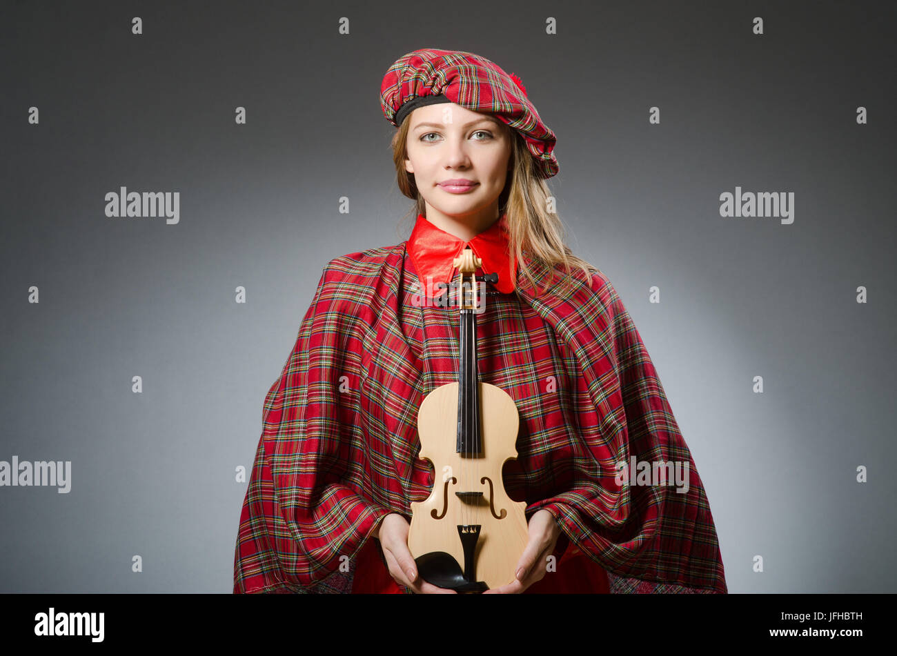 Woman in scottish clothing in musical concept Stock Photo