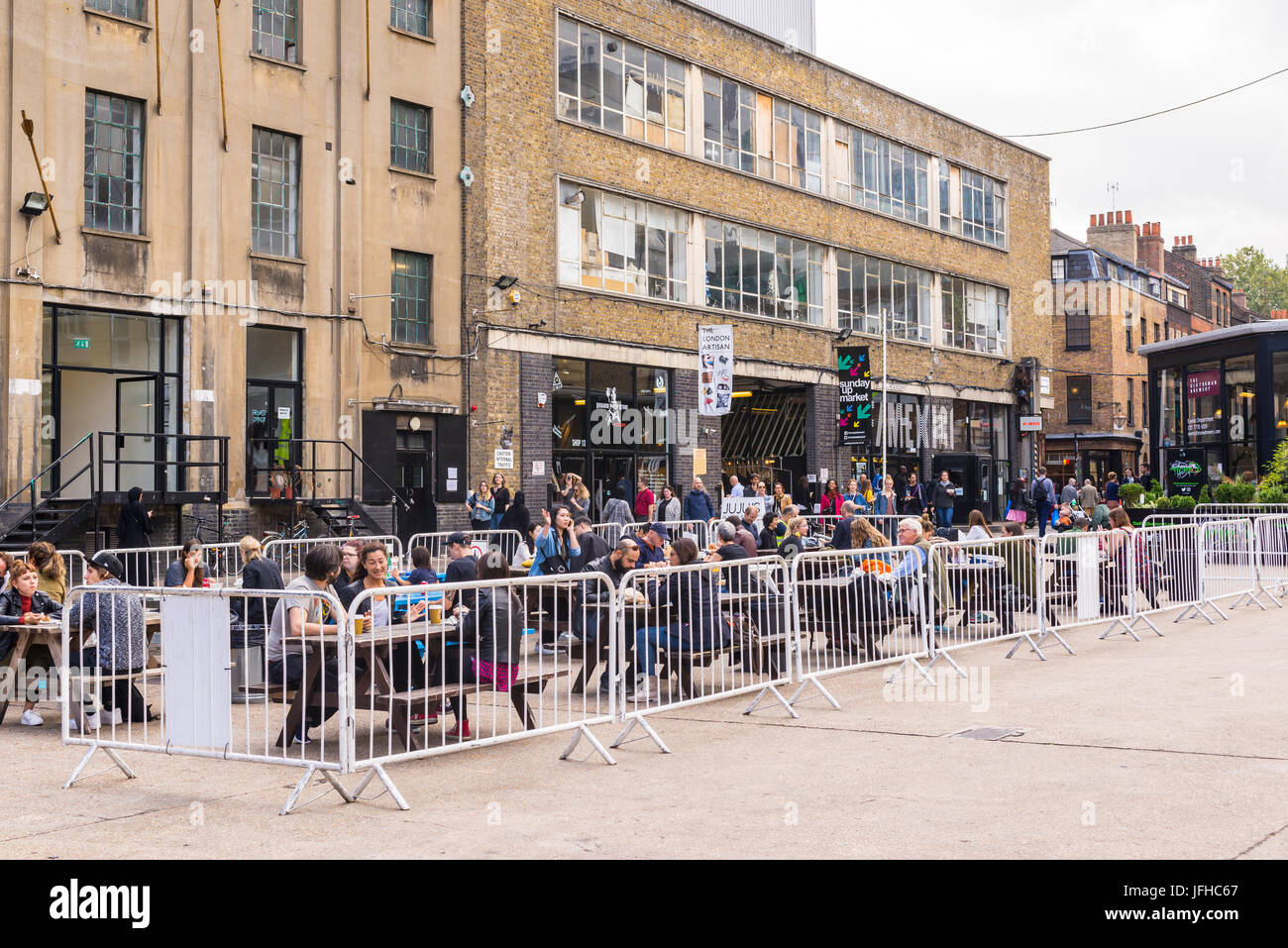 London, England - September 2016: Pop up Outdoor food area with people eating outiside at The Old Truman Brewery, Ely's Yard, Shoreditch, London, UK Stock Photo