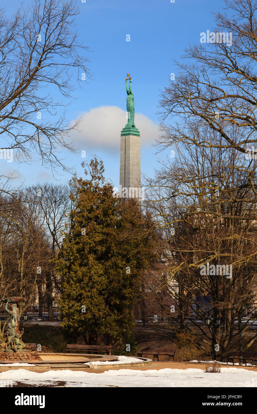 The Freedom Monument in Riga, Latvia viewed across City Canal.  The memorial honours the soldiers killed during the Latvian War of Independence. Stock Photo