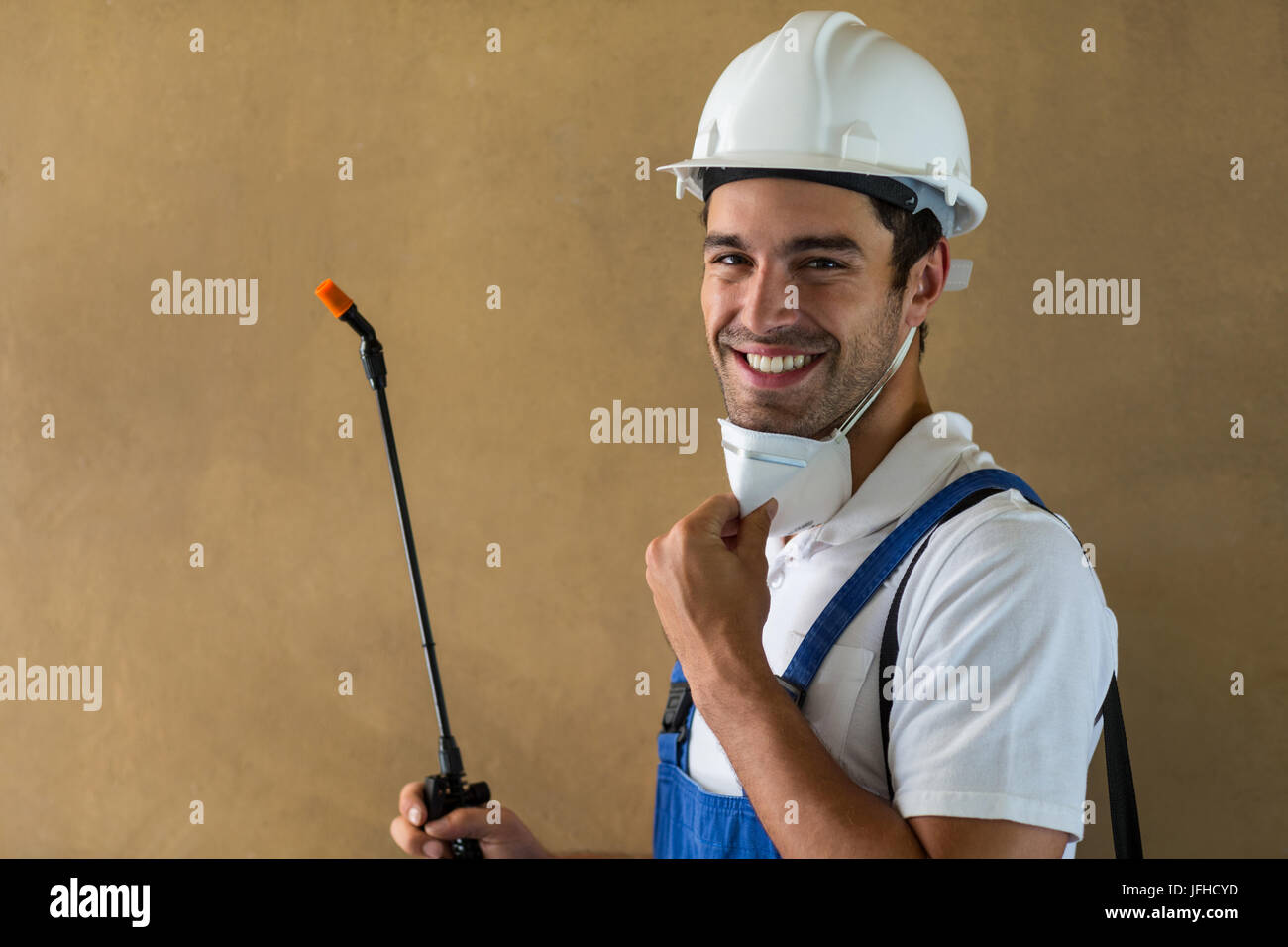 Portrait of happy manual worker with pesticide Stock Photo