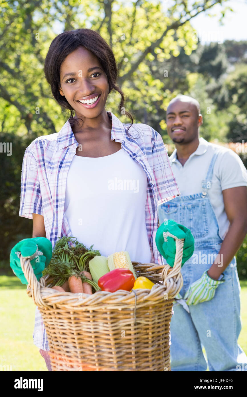 Young woman holding a basket of freshly harvested vegetables Stock ...