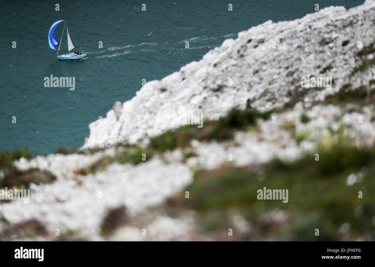 Sailing boats make their way around the Isle of Wight close to the Needles as they take part in the 2017 Round the Island Race. Stock Photo