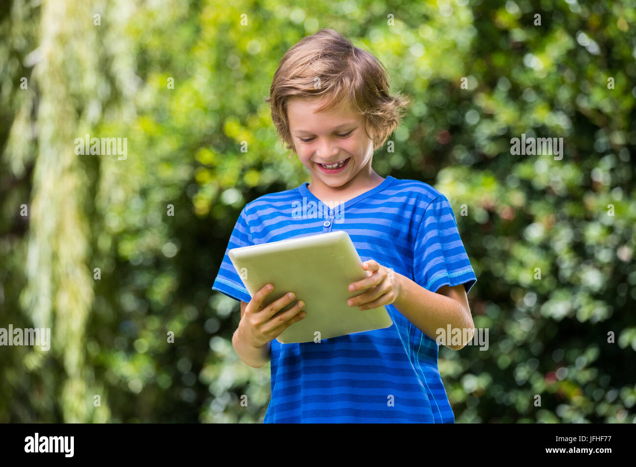 A little boy is playing with tablet computer Stock Photo - Alamy