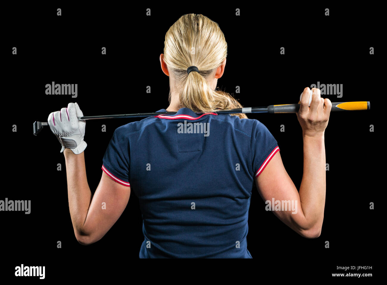 Rear view of golf player holding a golf club Stock Photo