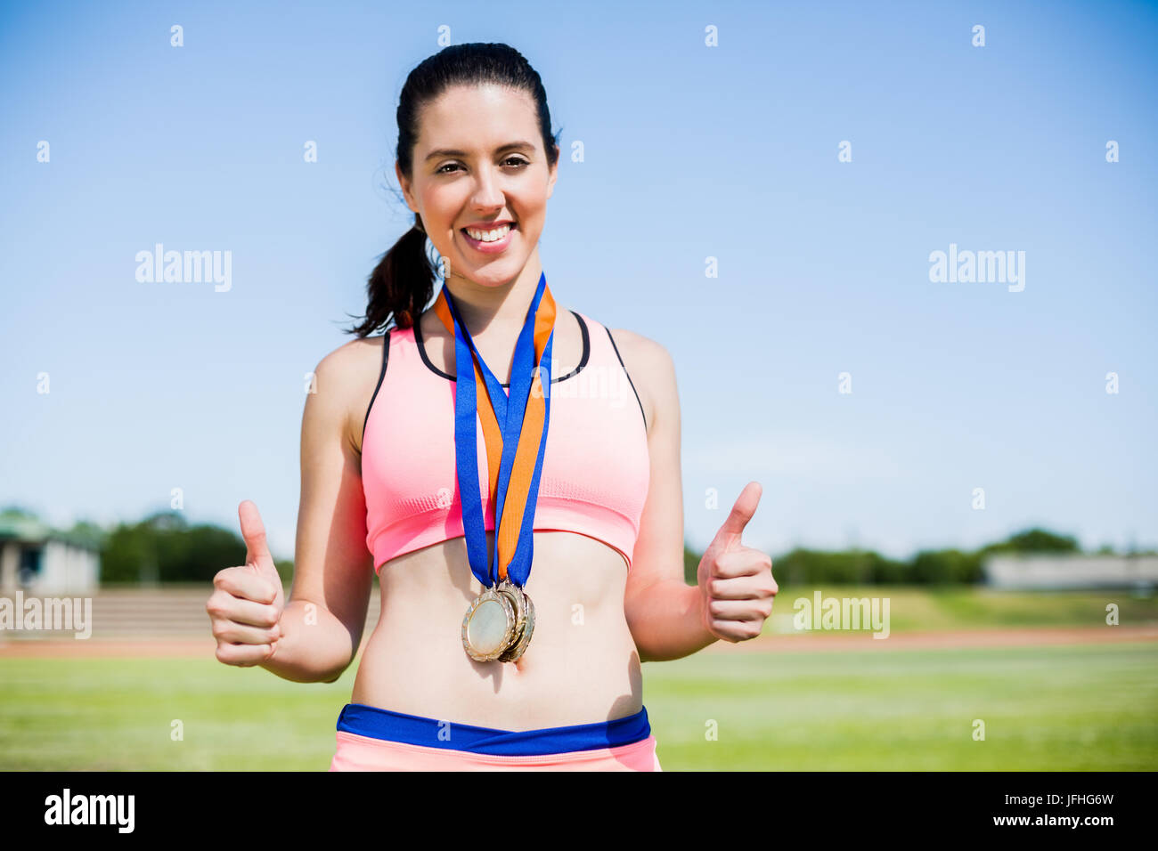 Female athlete with gold medals around her neck Stock Photo