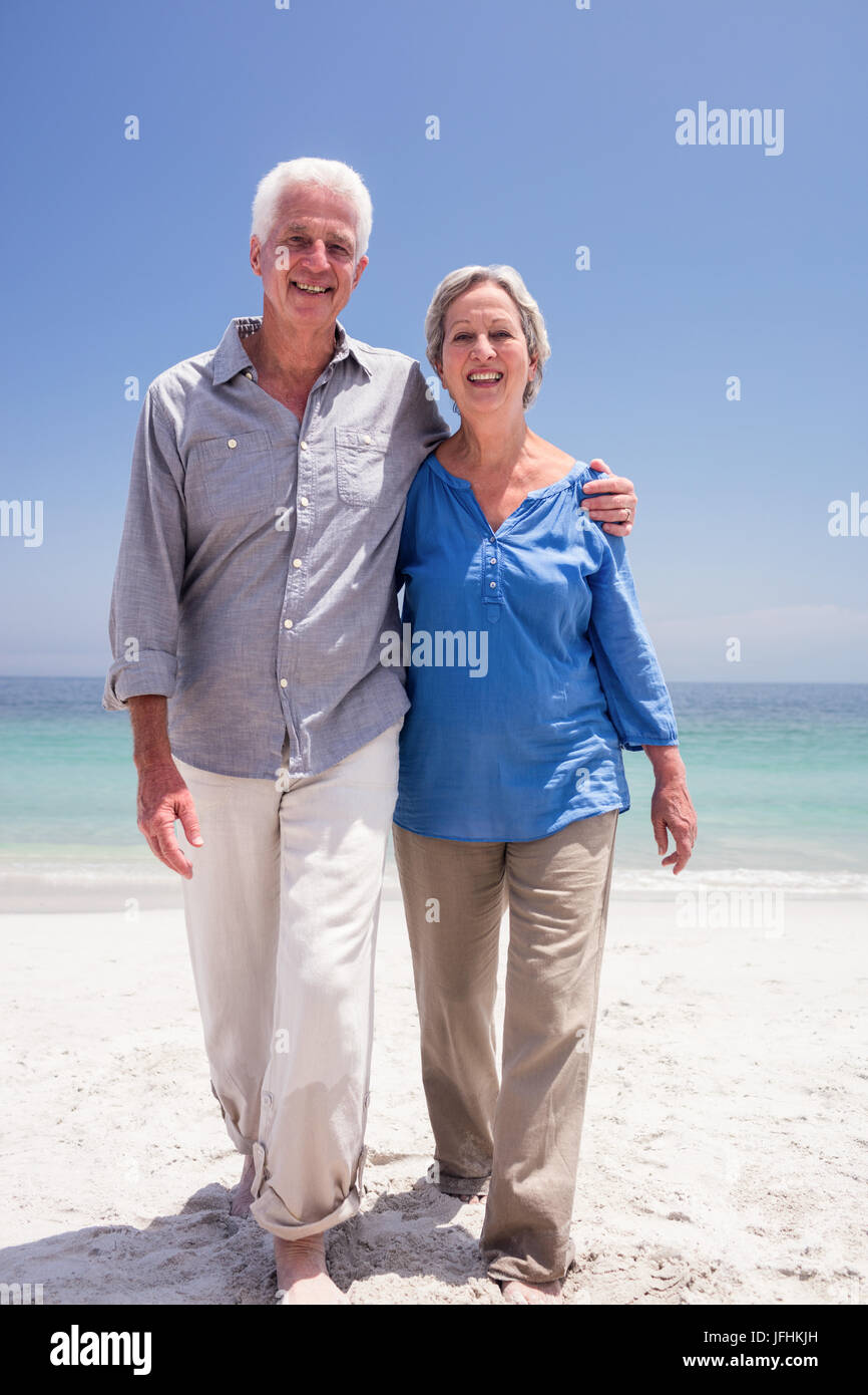 Portrait of happy senior couple walking on the beach Stock Photo - Alamy