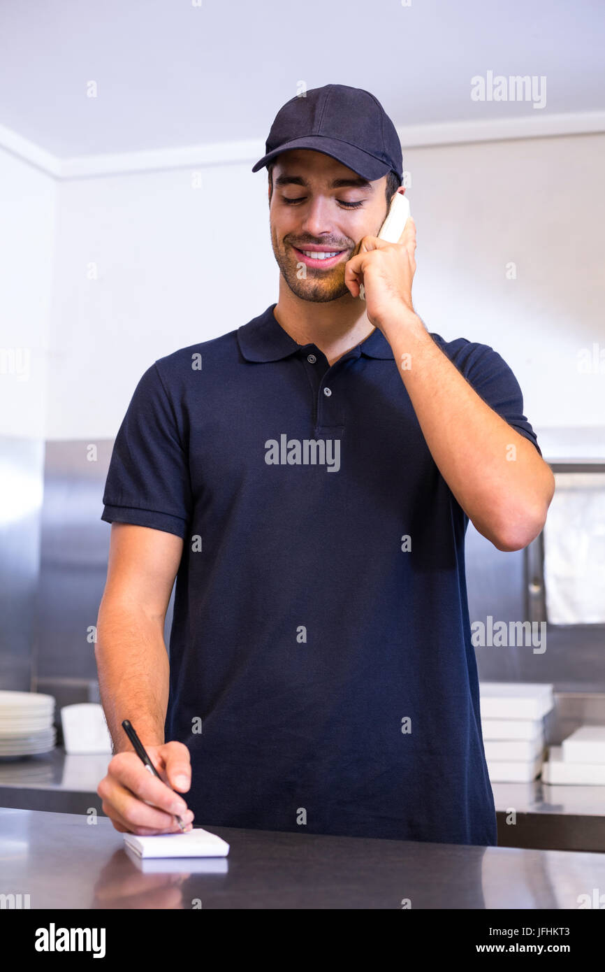Pizza delivery man taking an order over the phone Stock Photo Alamy