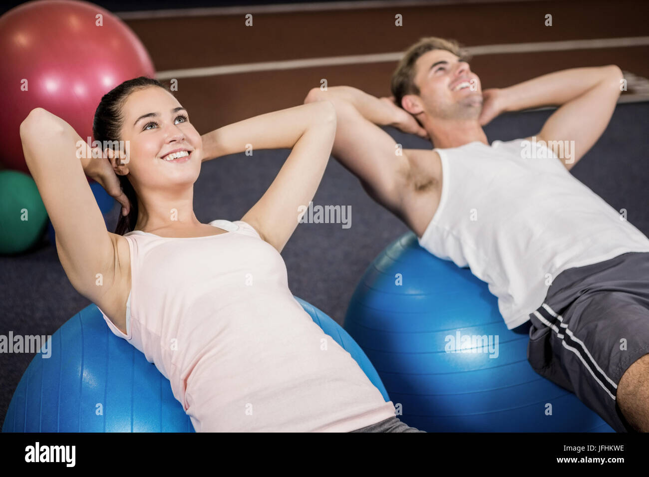 Man and woman doing abdominal crunches on fitness ball Stock Photo Alamy