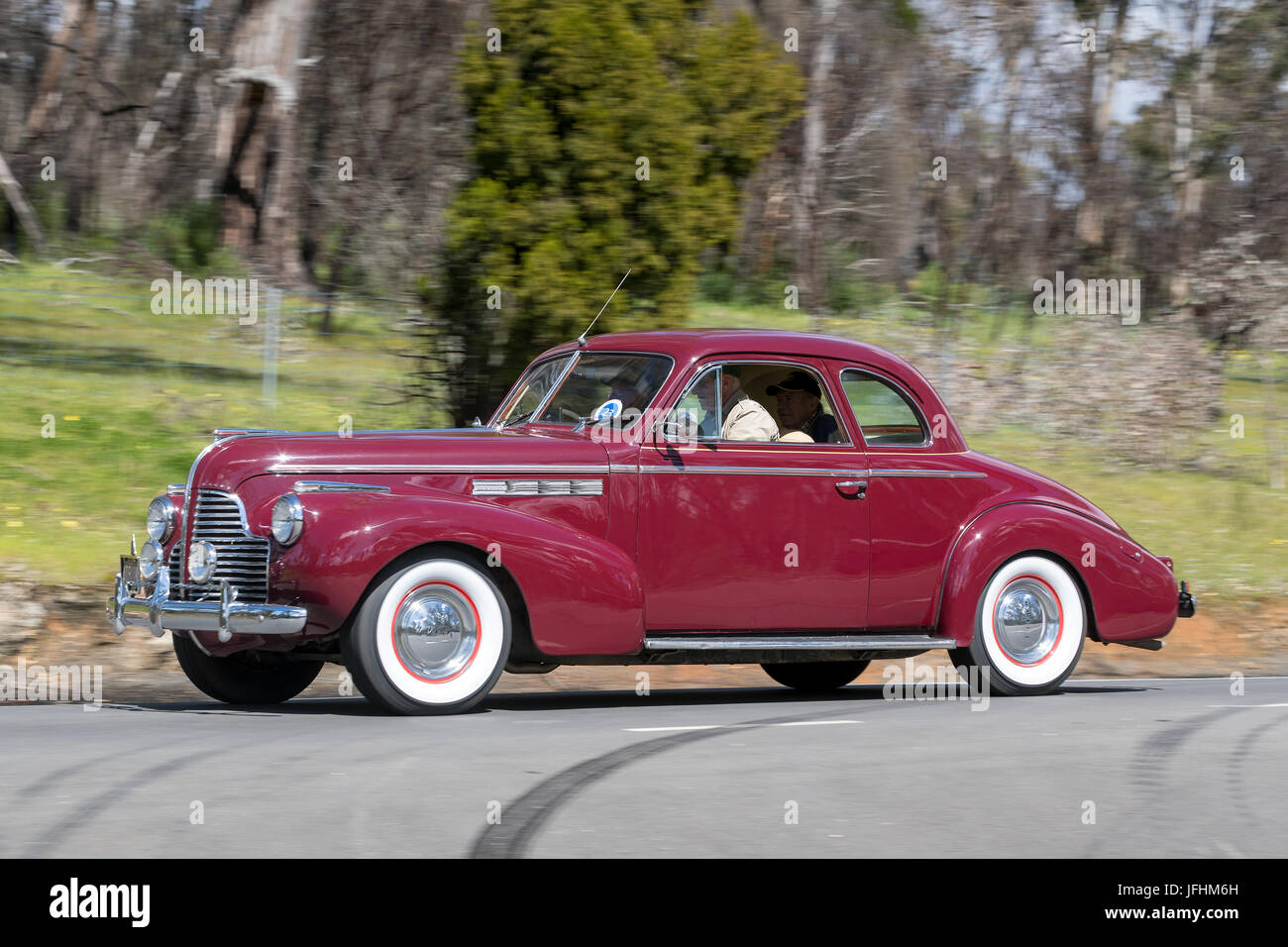 Vintage 1940 Buick Special Coupe driving on country roads near the town of Birdwood, South Australia. Stock Photo