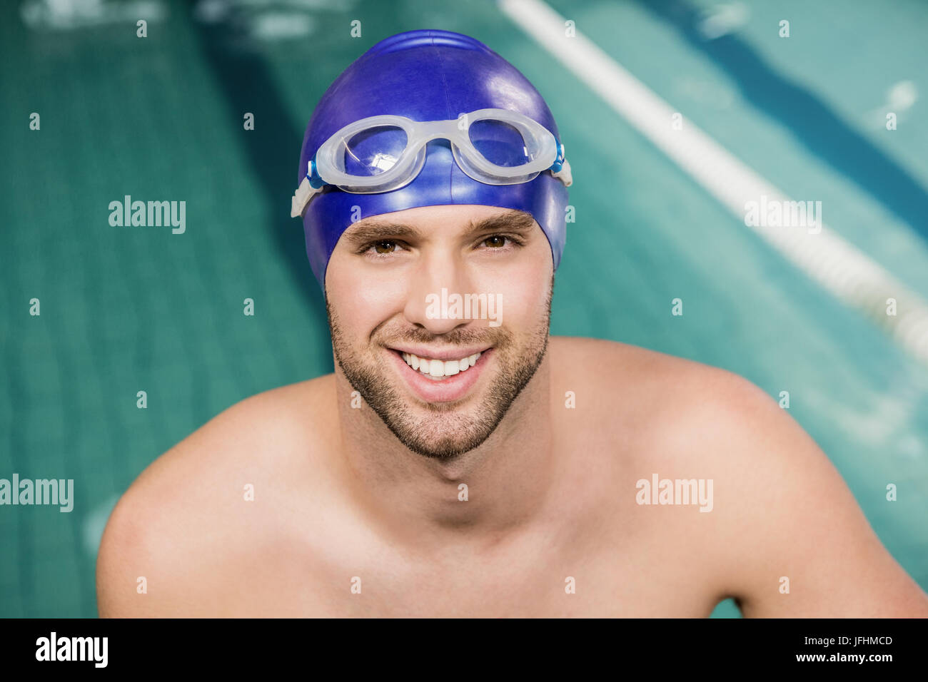 Portrait of swimmer wearing swimming goggles and cap Stock Photo