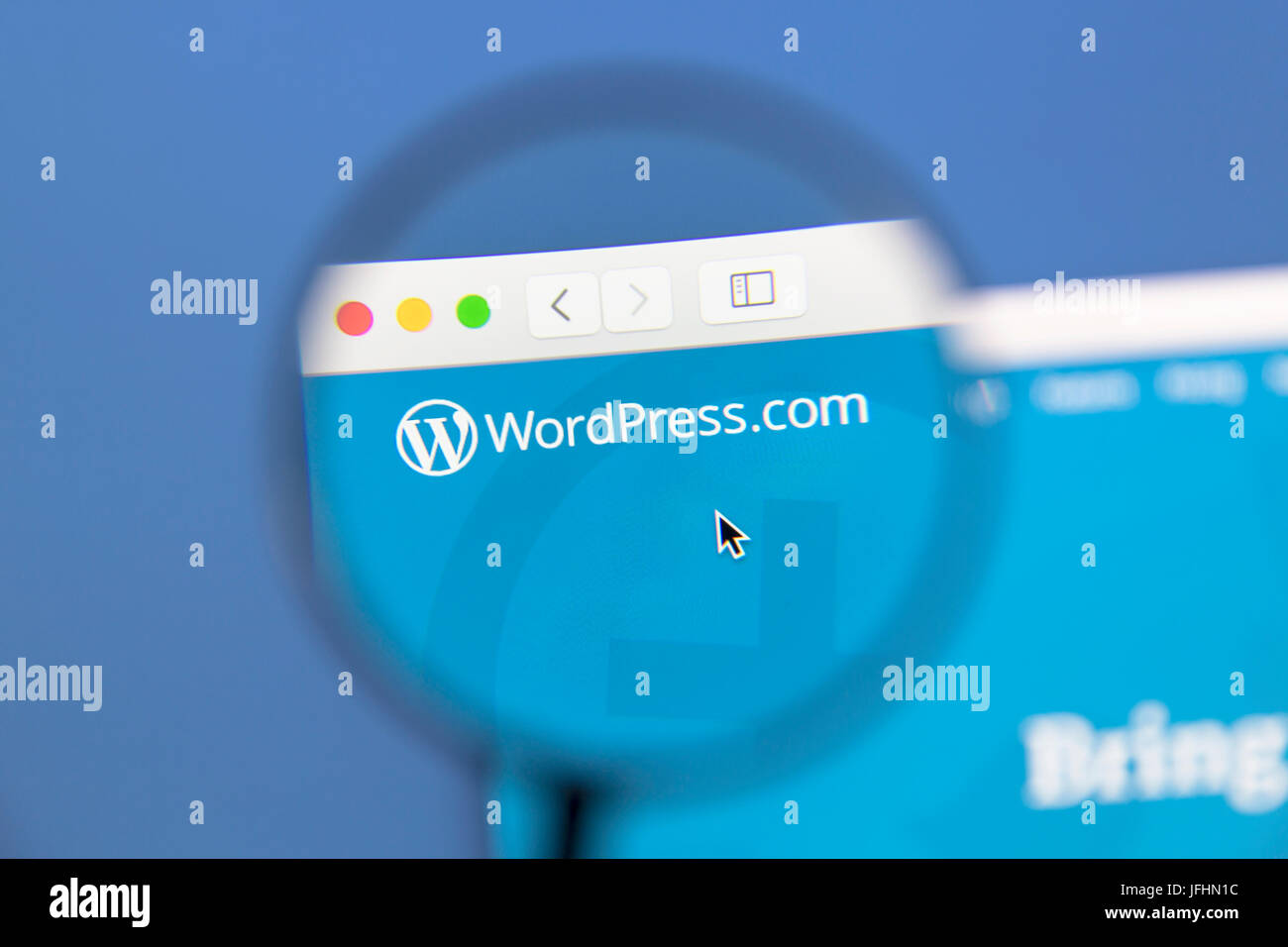 Wordpress website under a magnifying glass. WordPress is a free and open source blogging tool. Stock Photo