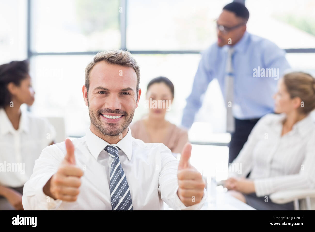 Portrait of businessman showing her thumbs up Stock Photo - Alamy