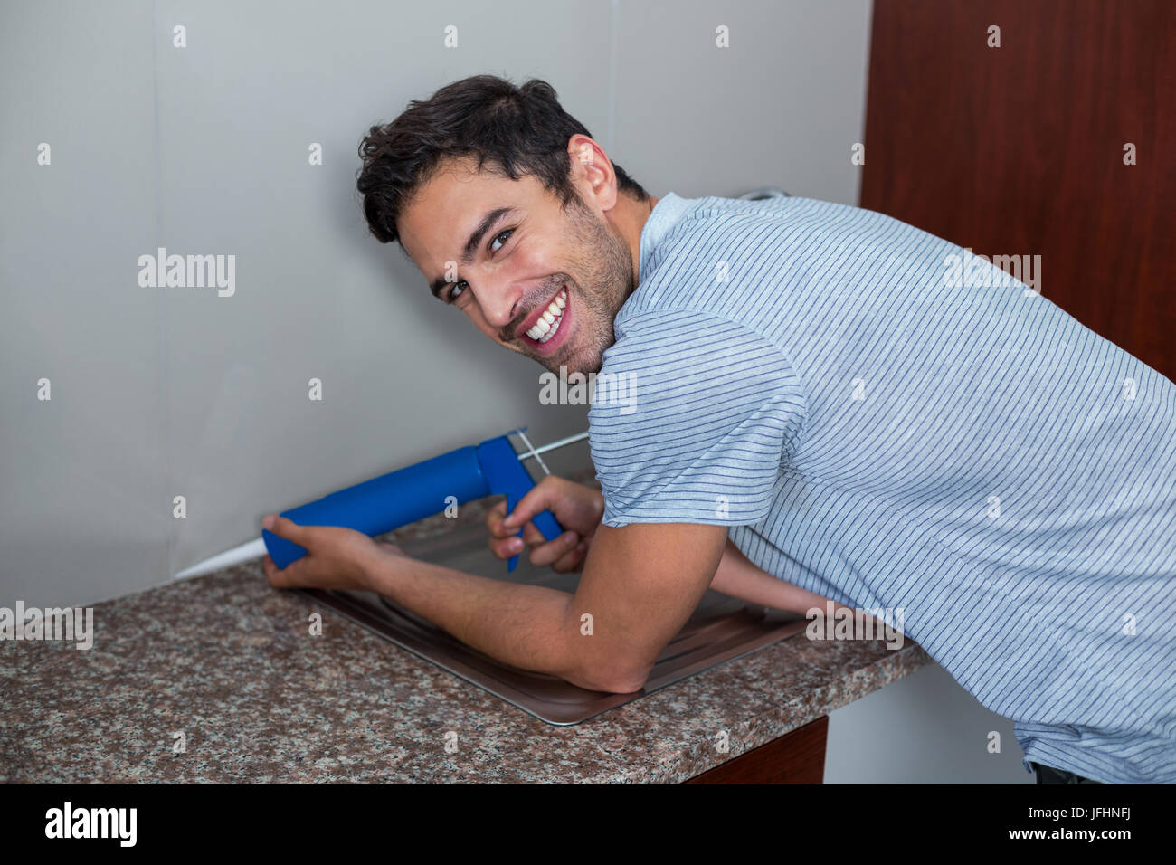 Portrait of smiling man using pest control injection Stock Photo - Alamy