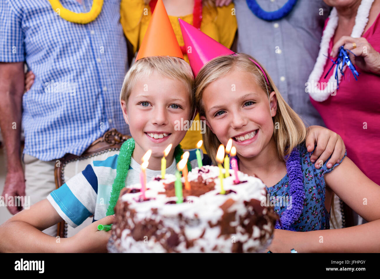 Siblings celebrating birthday party with family Stock Photo - Alamy