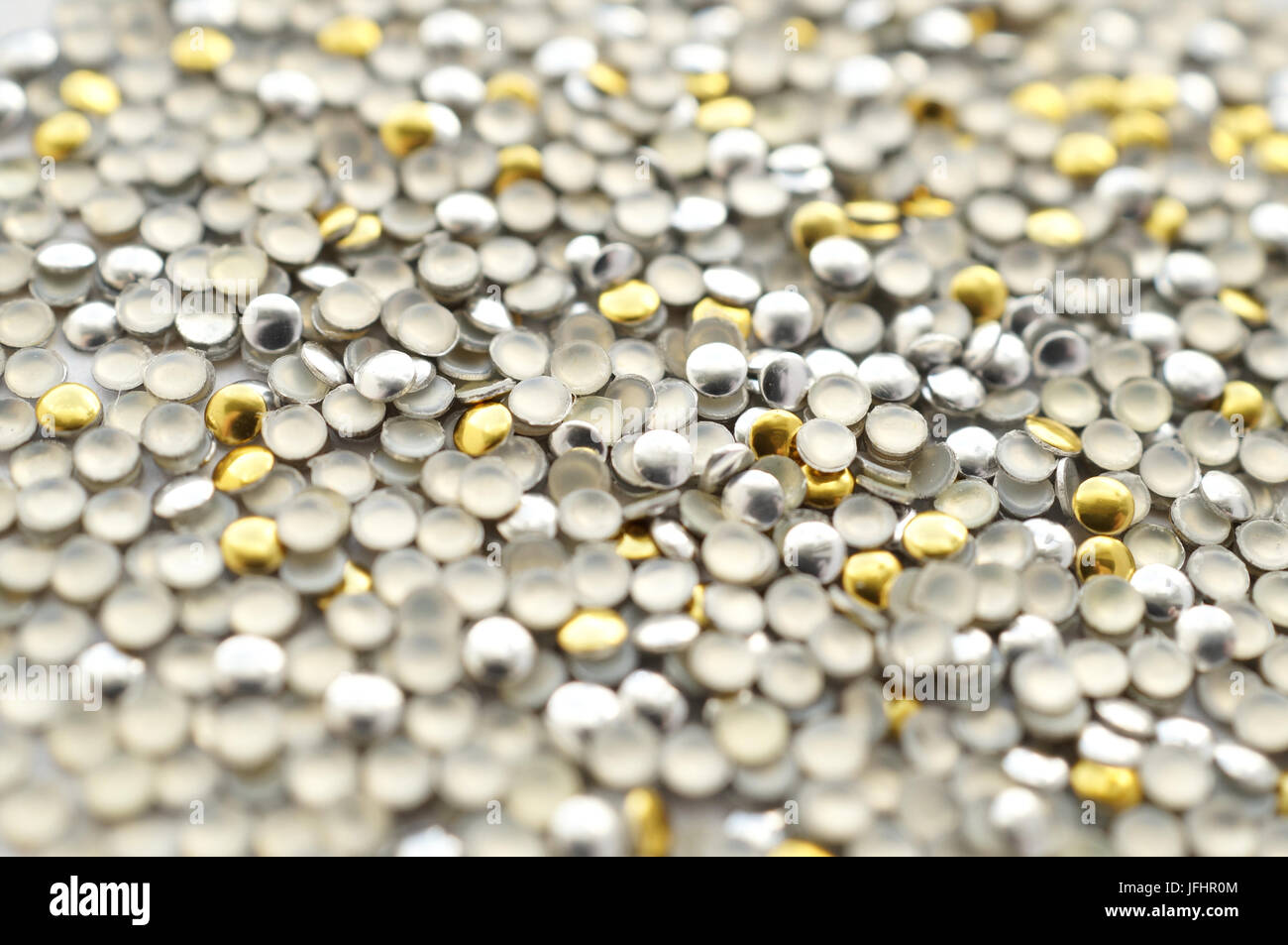 Mix of metal gold and silver thermo-adhesive rhinestones Stock Photo