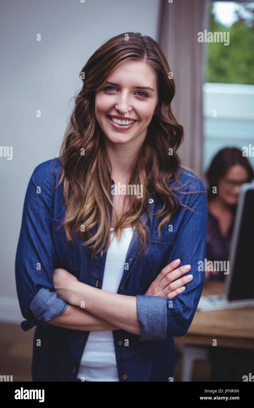 Portrait of beautiful woman standing with arms crossed Stock Photo - Alamy