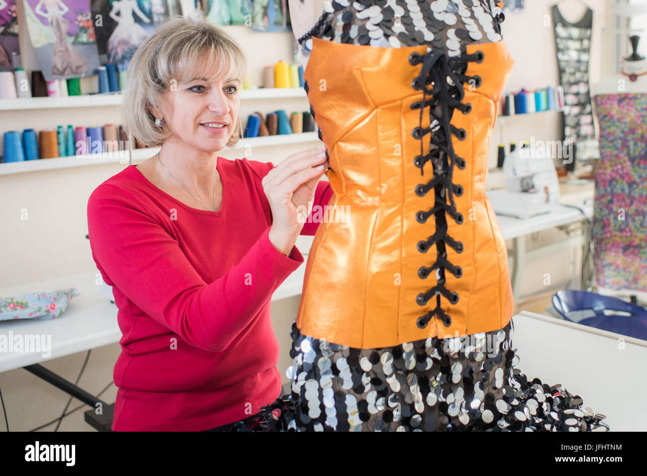 Dressmaker altering bodice on mannequin Stock Photo