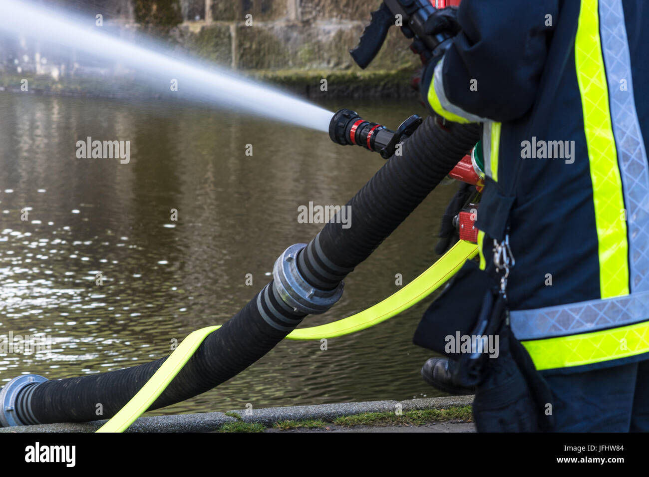 Fire department sprayed extinguishing water during an exercise. Stock Photo