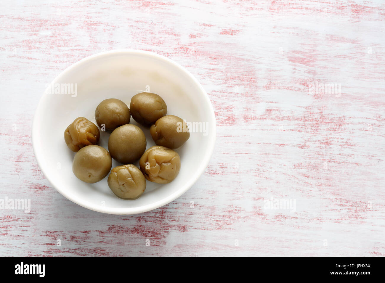 Pickled Plums on Textured Background Stock Photo - Alamy