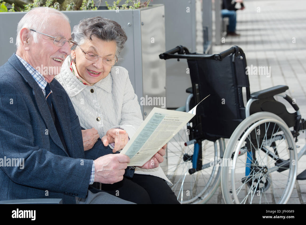 reading the news while sitting on a bench Stock Photo Alamy