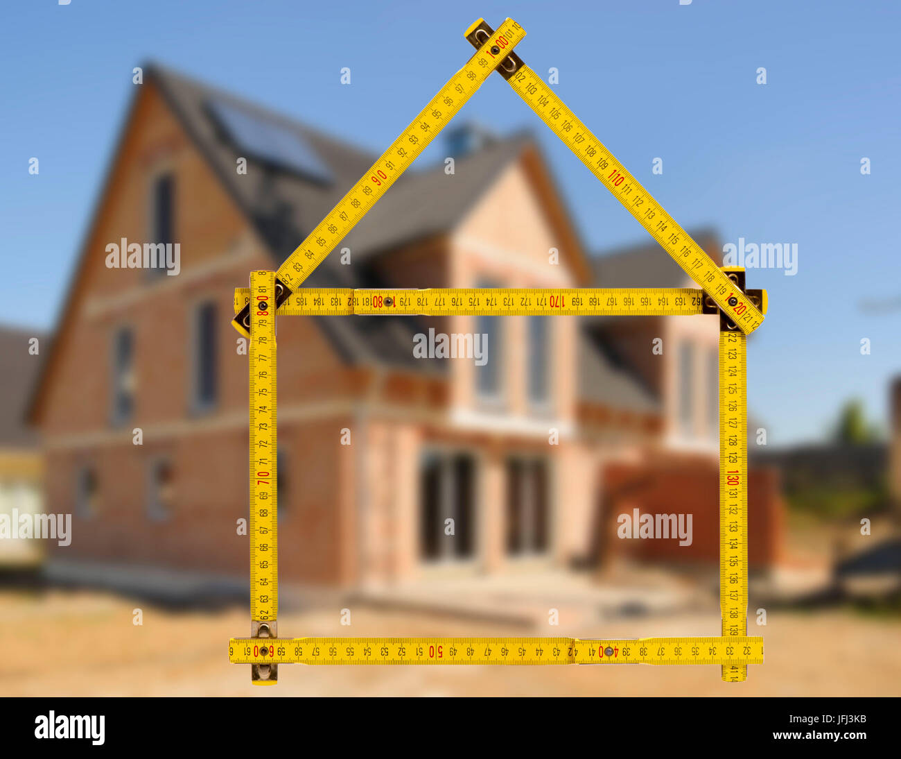 Building of a house and sales with yard stick as an icon Stock Photo