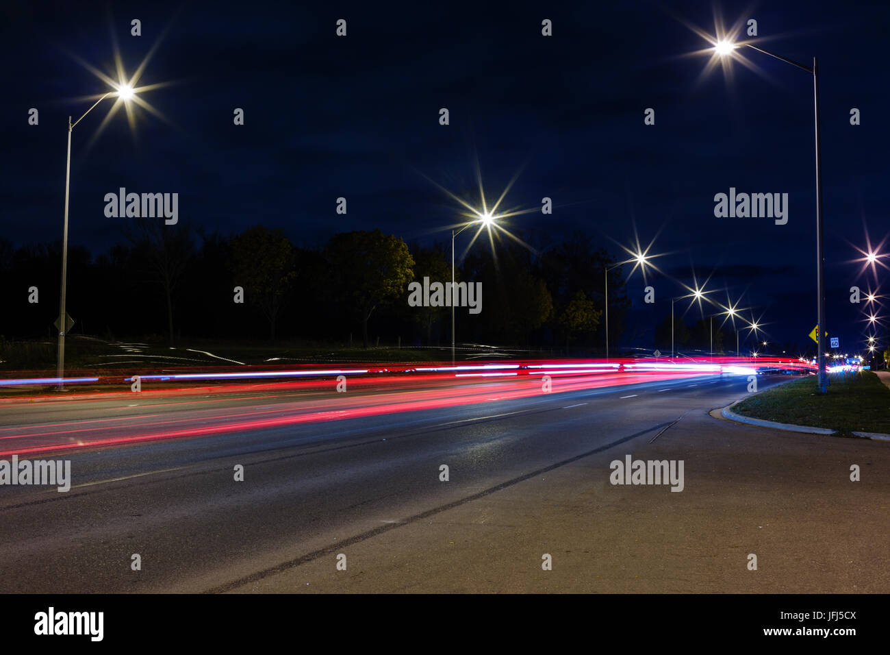 Road traffic and light trails at night Stock Photo - Alamy