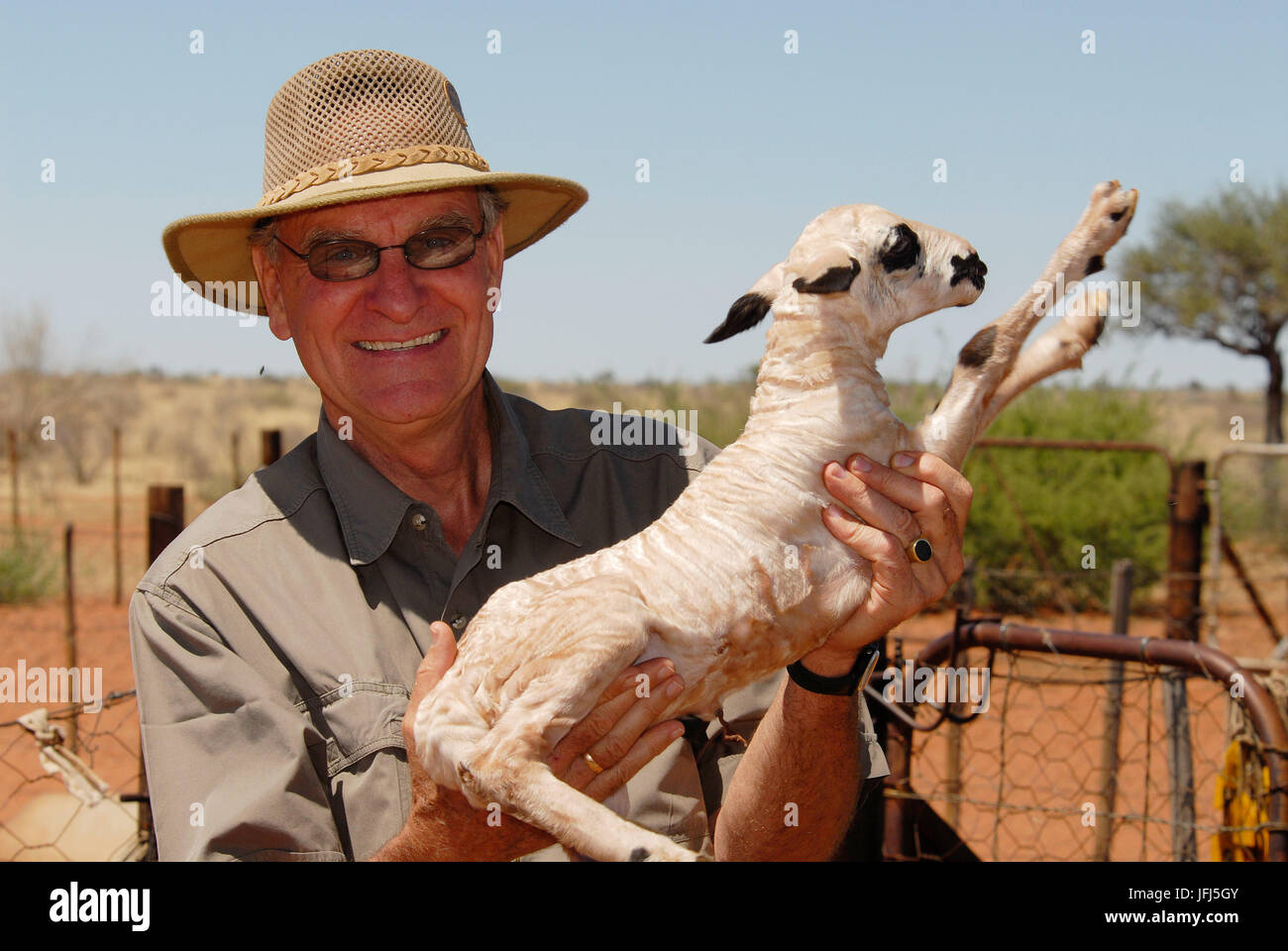 Africa, Namibia, Kalahari, Hoachanas, farm Jena, Raimar von Hase with 1 day old Karakul lamb Stock Photo